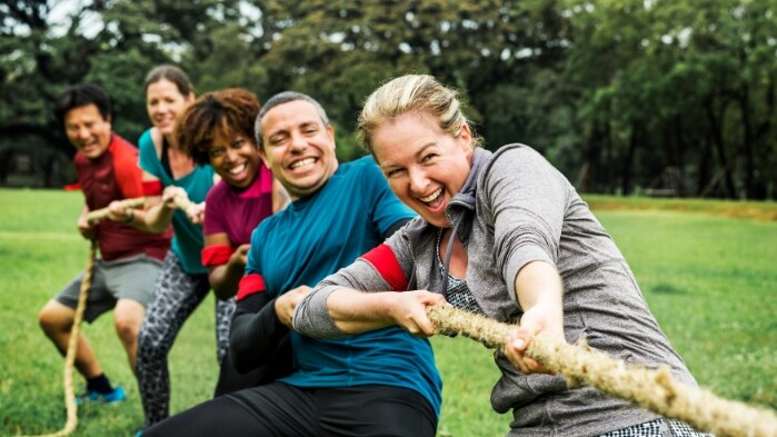 Multiple people playing tug of war